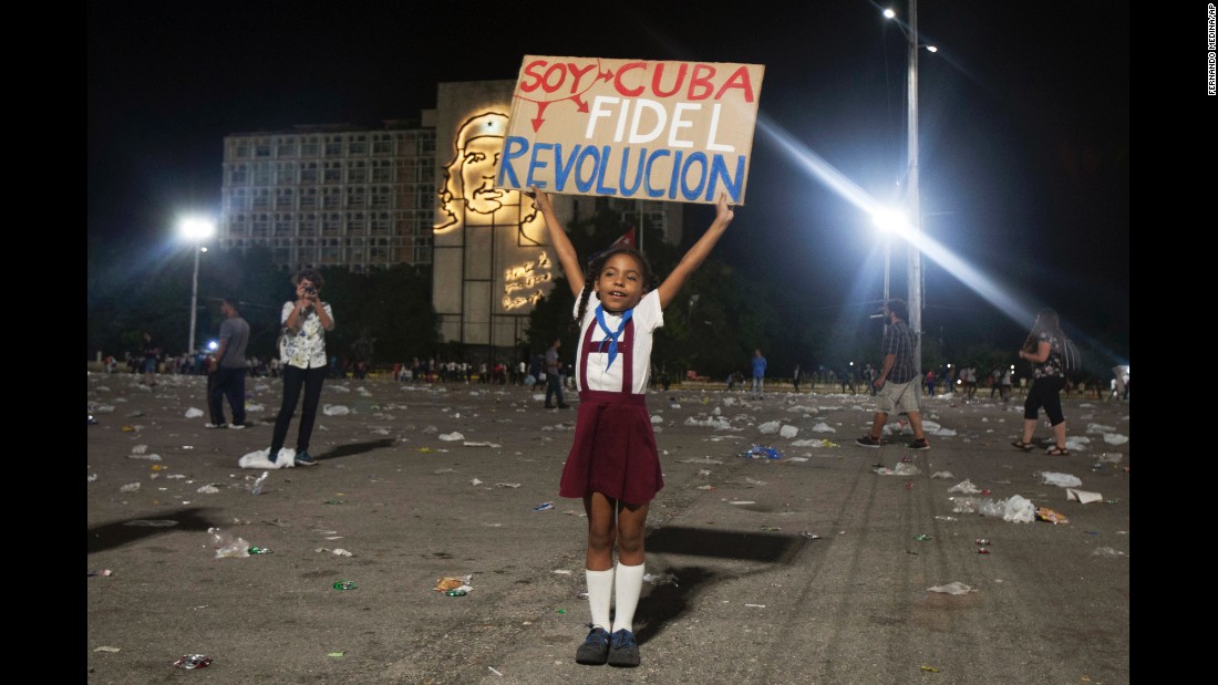 A girl in Havana holds a sign that reads &quot;I am Cuba. I am Fidel. I am revolution&quot; on Tuesday, November 29.