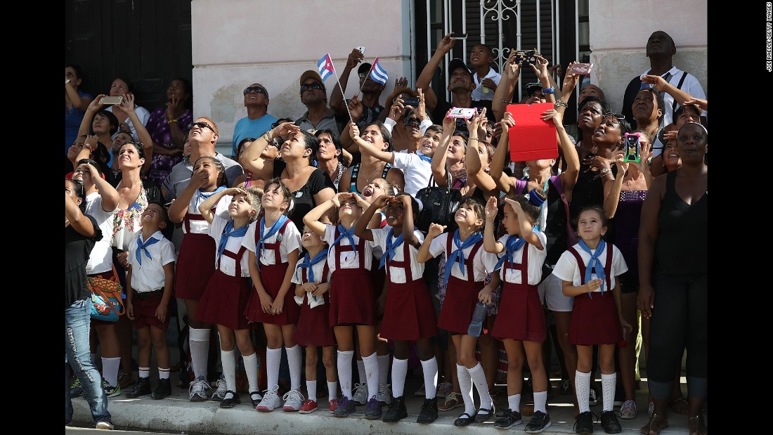 Schoolchildren react as a helicopter passes overhead in Cardenas, Cuba, on November 30.