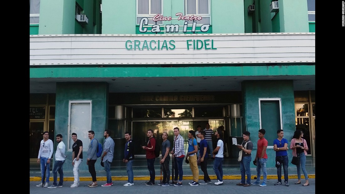 People line up to pay their final respects at a Castro memorial in Santa Clara on November 30. The theater marquee reads &quot;Thank you Fidel&quot; in Spanish.