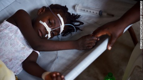 A young girl, with cholera symptoms is treated at the Cholera Treatment Center of Diquini in Port-au-Prince, Haiti on 23 August, 2016. 
The cholera epidemic that started in 2010 has infected some 800,000 and killed nearly 10,000 people.  / AFP / HECTOR RETAMAL        (Photo credit should read HECTOR RETAMAL/AFP/Getty Images)