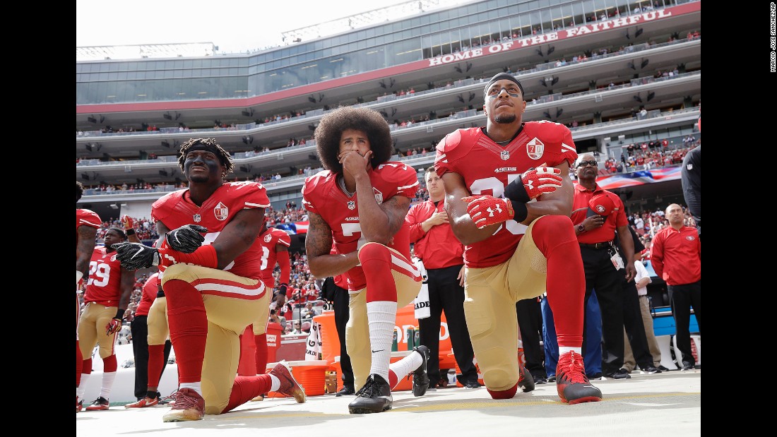 From left, San Francisco 49ers Eli Harold, Colin Kaepernick and Eric Reid kneel in protest during the national anthem on Sunday, October 2. Since the beginning of the season, Kaepernick &lt;a href=&quot;http://www.cnn.com/2016/09/01/sport/nfl-preseason-49ers-chargers-colin-kaepernick-national-anthem/&quot; target=&quot;_blank&quot;&gt;has refused to stand during the national anthem&lt;/a&gt; because he will not &quot;show pride in a flag for a country that oppresses black people and people of color.&quot;