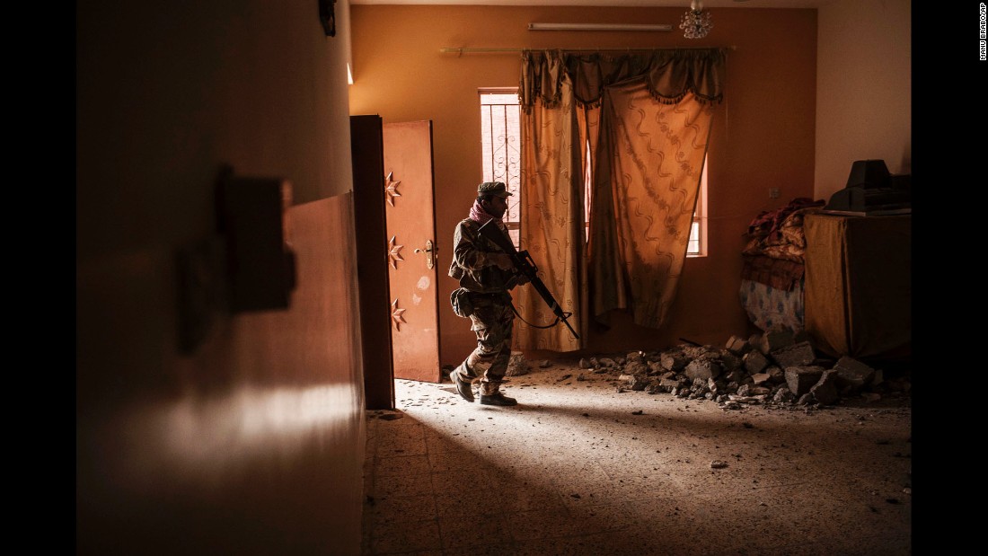 An Iraqi soldier searches a home for ISIS militants after Iraqi forces retook the village of Al-Qasr on Wednesday, November 30.