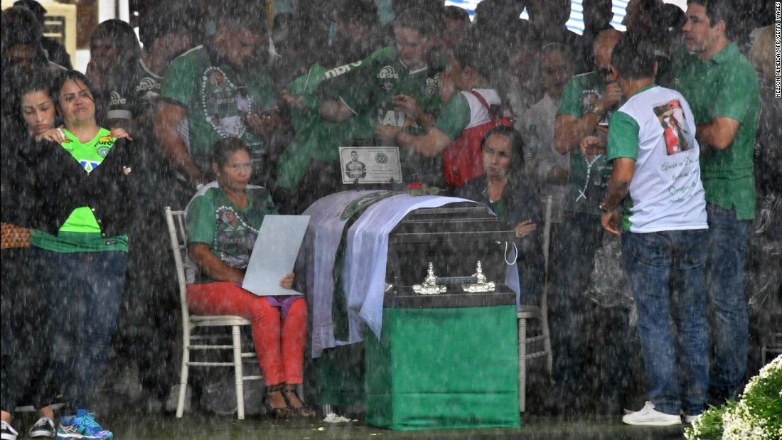 Relatives mourn over the coffin of one of the Chapecoense players at the stadium.