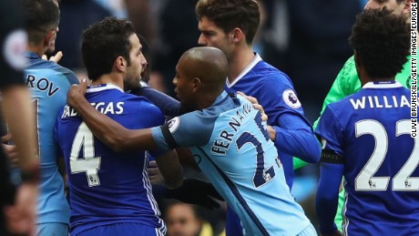 Fernandinho grabs Cesc Fabregas in the clashes in stoppage time. The Manchester City player was red carded in the incident.