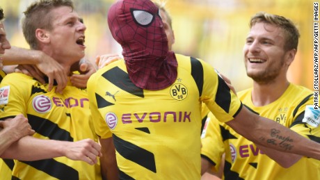Dortmund&#39;s Italian striker Circo Immobile (R), Dortmund&#39;s Polish defender Lukasz Piszczek (L) celebrate after Dortmund&#39;s Gabonese striker Pierre-Emerick Aubameyang, who put on a Spiderman mask, scored the 2-0 goal during the German Supercup football match Borussia Dortmund vs Bayern Munich in the German city of Dortmund on August 13, 2014. AFP PHOTO / PATRIK STOLLARZ

DFL RULES TO LIMIT THE ONLINE USAGE DURING MATCH TIME TO 15 PICTURES PER MATCH. IMAGE SEQUENCES TO SIMULATE VIDEO IS NOT ALLOWED AT ANY TIME. FOR FURTHER QUERIES PLEASE CONTACT DFL DIRECTLY AT + 49 69 650050.        (Photo credit should read PATRIK STOLLARZ/AFP/Getty Images)