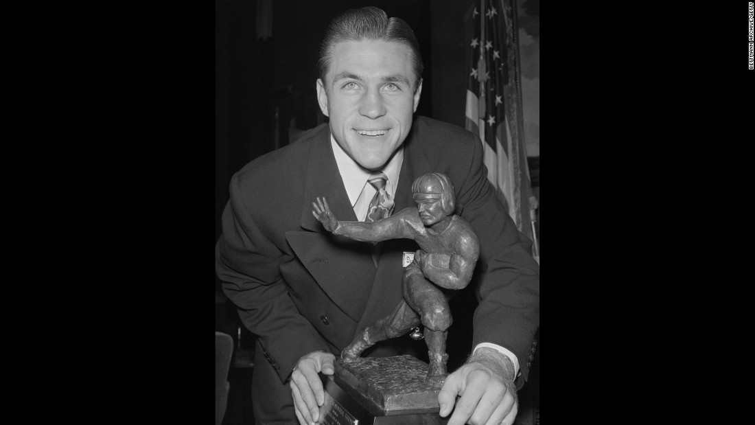 Doak Walker, a halfback for Southern Methodist University, with his Heisman Trophy during a dinner at the Downtown Athletic Club in New York on December 7, 1948. The trophy was established in 1935 and is awarded annually to an &quot;outstanding college football player whose performance best exhibits the pursuit of excellence with integrity,&quot; &lt;a href=&quot;http://heisman.com/sports/2014/9/15/GEN_0915145605.aspx&quot; target=&quot;_blank&quot;&gt;according to the Heisman Trust&lt;/a&gt;.