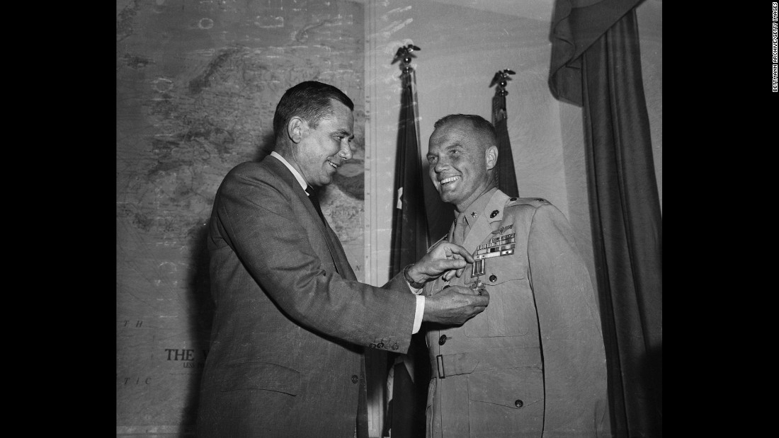 Glenn receives a Distinguished Flying Cross from then-Navy Secretary Thomas Gates at the Pentagon.