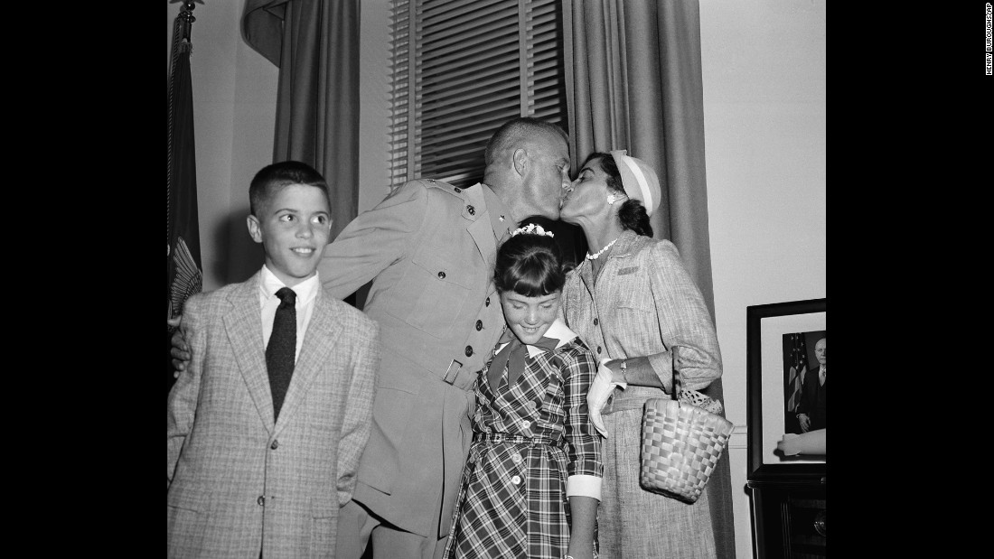 Glenn and his wife, Annie, sandwich their daughter, Carolyn &quot;Lyn,&quot; as they embrace following a ceremony honoring his feat. Son David is at left.