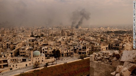 TOPSHOT - A general view taken from Aleppo&#39;s citadel show fumes rising following shelling on neighbourhoods in the old city on December 7, 2016. / AFP / GEORGE OURFALIAN        (Photo credit should read GEORGE OURFALIAN/AFP/Getty Images)