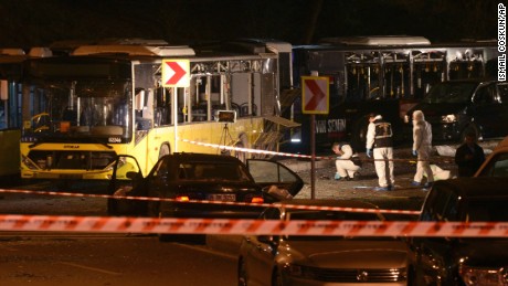 Forensic officials work at the scene of explosions near a stadium in Istanbul.