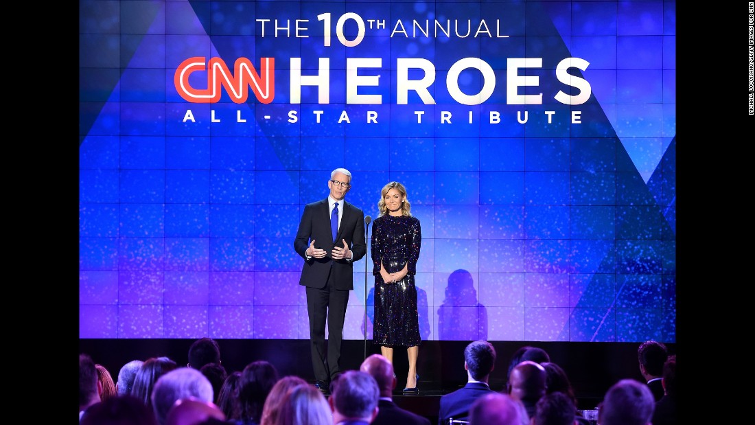 Hosts Anderson Cooper and Kelly Ripa speak onstage during the CNN Heroes gala 2016 at the American Museum of Natural History on Sunday, December 11, in New York.