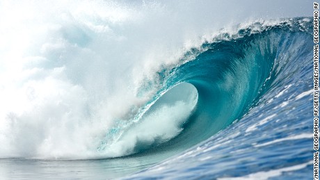 A perfect waves breaks in Teahupoo, Tahiti showing the tube.