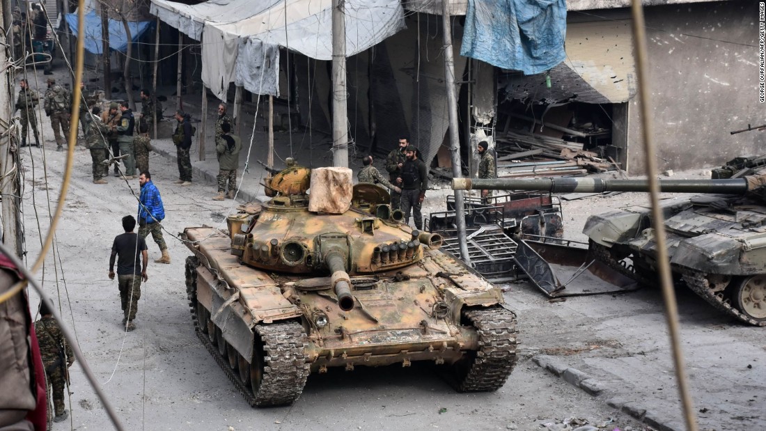 Pro-government forces patrol the al-Saleheen neighborhood in eastern Aleppo on December 12.