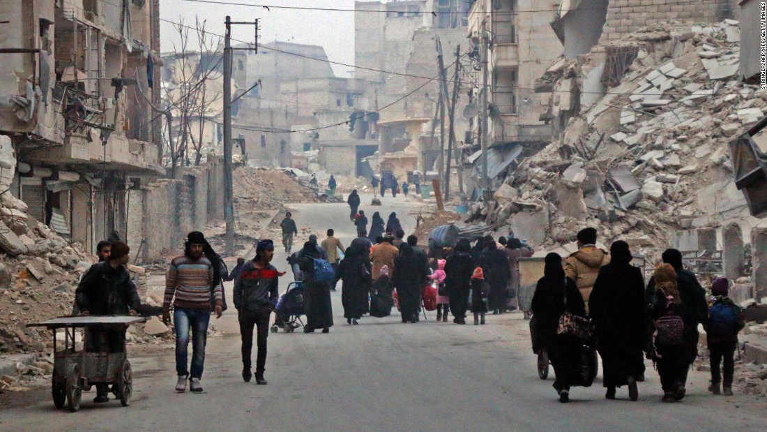 Civilians flee the Sukkari neighborhood in southeastern Aleppo on December 12.