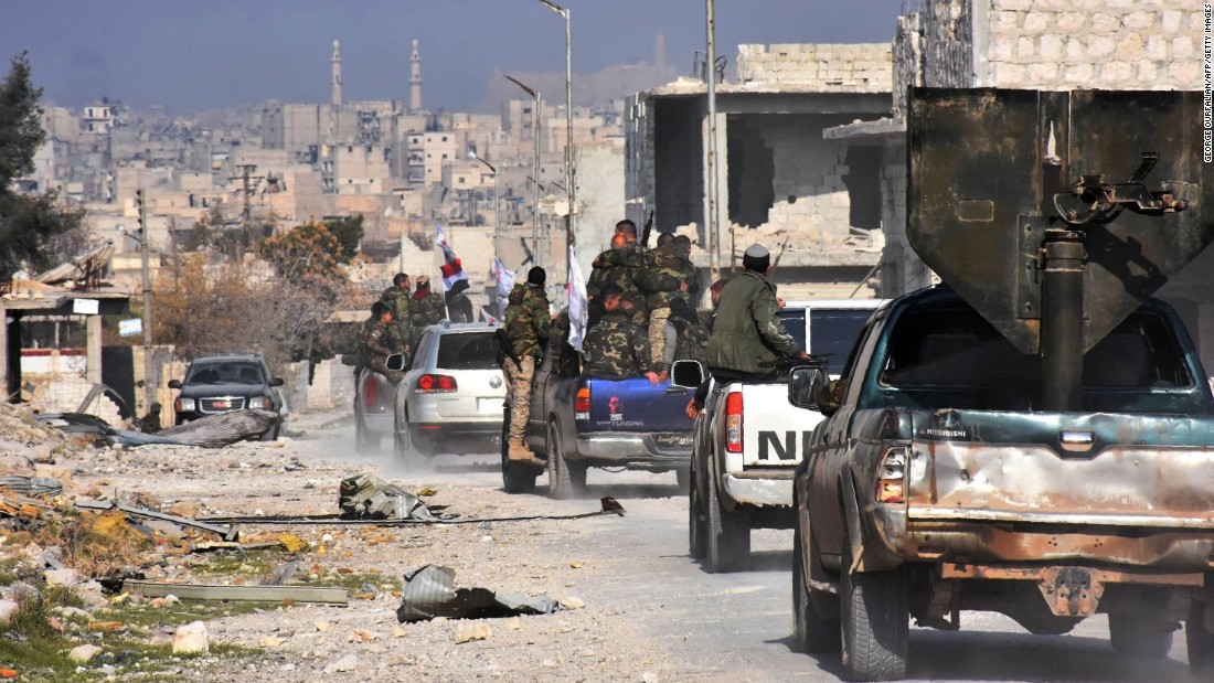 Pro-government forces patrol Aleppo&#39;s Sheikh Saeed district on December 12 after it was recaptured from rebel forces.