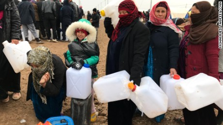 Shelter, food and water are provided, but refugees must wait in line to collect supplies.