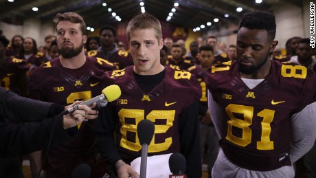 University of Minnesota wide receiver Drew Wolitarsky, flanked by quarterback Mitch Leidner, left, and tight end Duke Anyanwu stands in front of other team members as he reads a statement on behalf of the players in the Nagurski Football Complex in Minneapolis, Minn., Thursday night, Dec. 15, 2016.  The players delivered a defiant rebuke of the university&#39;s decision to suspend 10 of their teammates, saying they would not participate in any football activities until the school president and athletic director apologized and revoked the suspensions. If that meant they don&#39;t play in the upcoming Holiday Bowl against Washington State, they appeared poised to stand firm. (Jeff Wheeler/Star Tribune via AP)