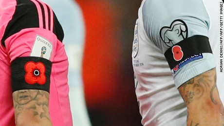 Players wore poppies on their armbands in a World Cup qualifier between England and Scotland.