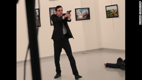 The gunman gestures shortly after Karlov was shot on December 19, 2016. 