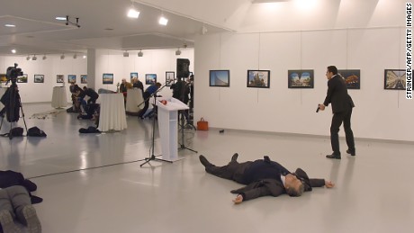 The Russian ambassador is shown on the floor after the gunman shot him.