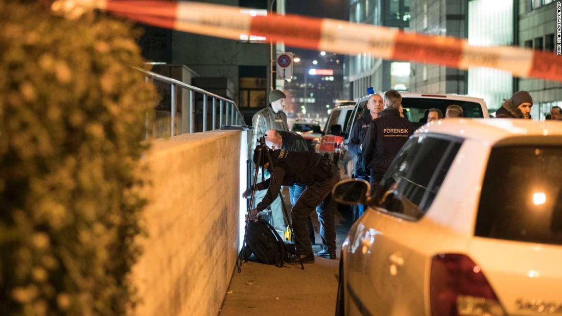 Police officers secure the area near an Islamic center in Zurich, Switzerland, after three people were shot there on Monday, December 19. A gunman, decked out in dark clothing, opened fire on a group of worshipers standing inside a prayer room, police said, citing eyewitnesses.