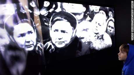 A visitor examines the multimedia displays showing Stalin&#39;s funeral during the opening ceremony of a new museum dedicated to the Soviet Gulag labour camp system in 2015.