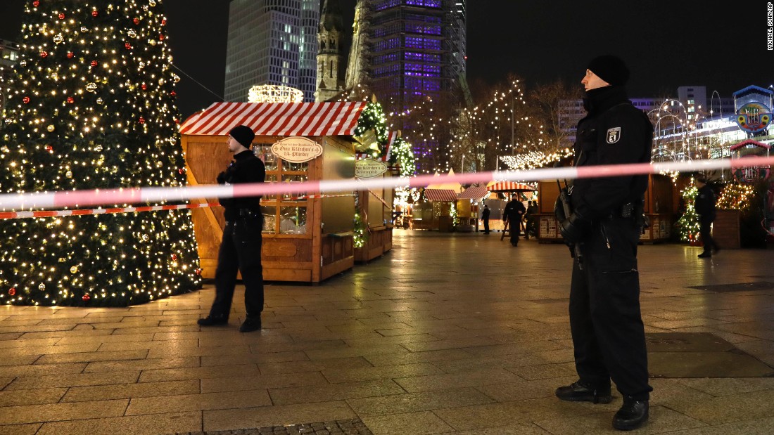 Police stand guard at the market after the crash.