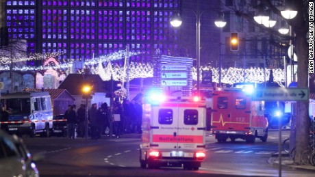 An ambulance and rescue workers arrive to the area after a lorry truck ploughed through a Christmas market on December 19, 2016 in Berlin, Germany. Several people have died while dozens have been injured as police investigate the attack at a market outside the Kaiser Wilhelm Memorial Church on the Kurfuerstendamm and whether it is linked to a terrorist plot.