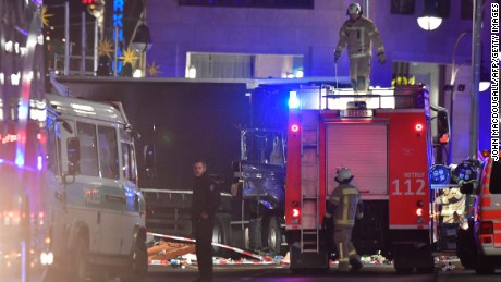 Rescue forces stand in front of the truck that speed into a Christmas market in Berlin, on December 19, 2016 killing nine persons and injuring at least 50 people.
Ambulances and police rushed to the scene after the driver drove up the pavement of the market in a central square popular with tourists less than a week before Christmas, in a scene reminiscent of the deadly truck attack in Nice. 