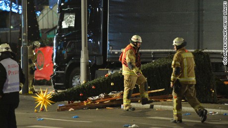 A Christmas tree lies next to a truck that slammed into a Christmas market at Gedächniskirche church. 
 