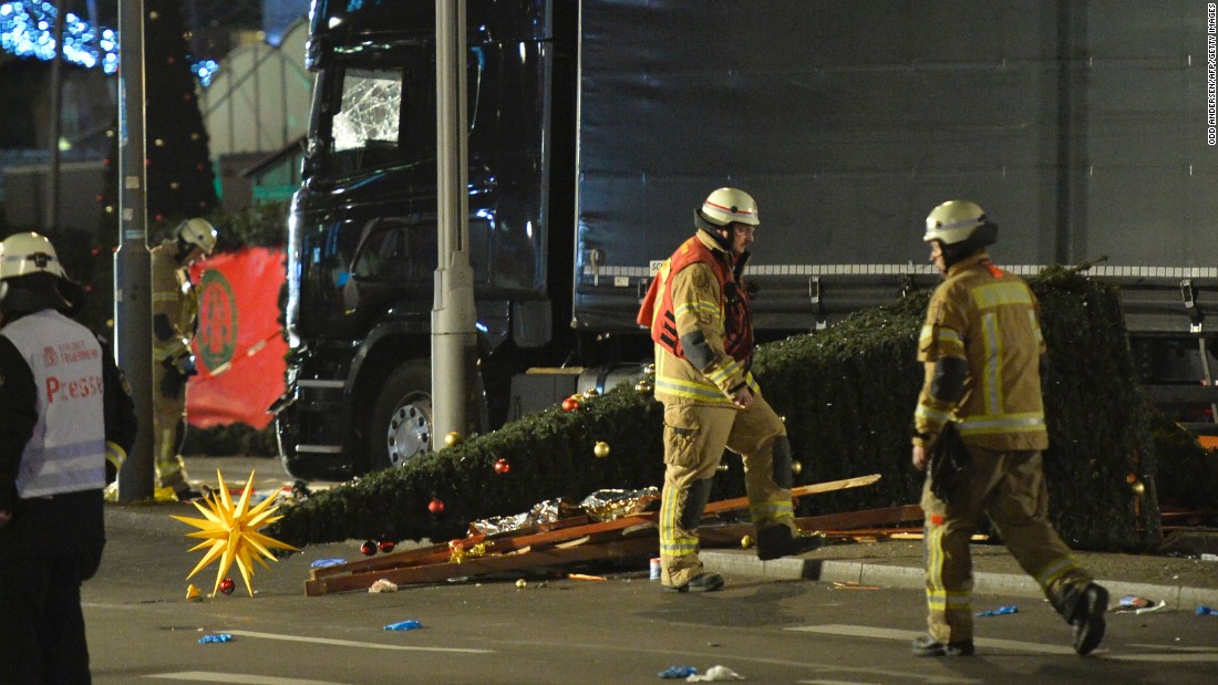 A Christmas tree lies next to the truck.