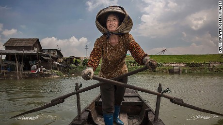 Chen Shourongon paddles her boat on Shazai Island, where the field release program is underway.