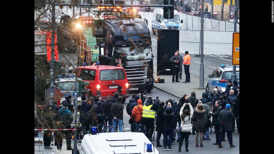 Members of the press crowd around the crash site on December 20.