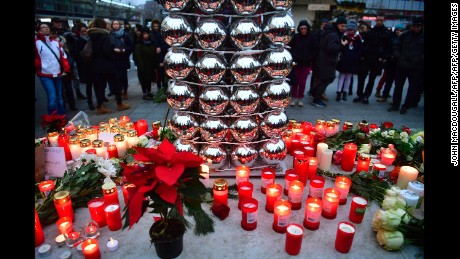Candles are lit on December 20, 2016 at a makeshift memorial in front of the Kaiser-Wilhelm-Gedaechtniskirche (Kaiser Wilhelm Memorial Church) in Berlin, where a truck crashed the day before into a Christmas market.
Twelve people were killed and almost 50 wounded, 18 seriously, when the lorry tore through the crowd on December 19, 2016, smashing wooden stalls and crushing victims, in scenes reminiscent of July's deadly attack in the French Riviera city of Nice. / AFP / John MACDOUGALL        (Photo credit should read JOHN MACDOUGALL/AFP/Getty Images)