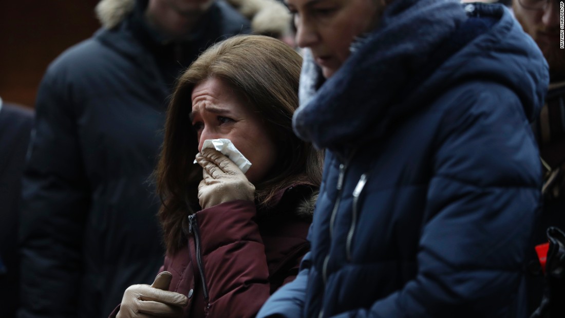 A woman reacts near the crime scene on December 20.