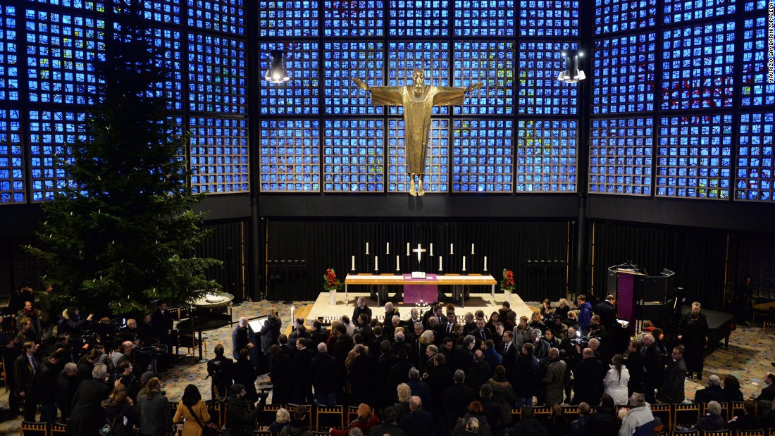 Mourners gather at the Kaiser Wilhelm Memorial Church near the crash site.