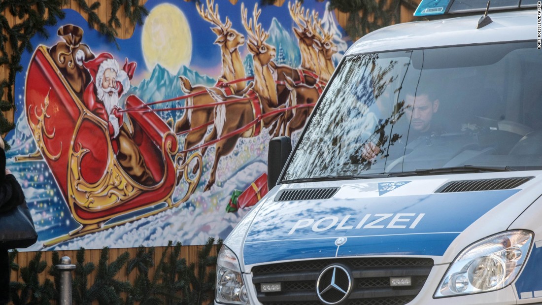 A police van drives by Christmas decorations at a Christmas market in Frankfurt, Germany, on December 20. Police presence has been stepped up at Christmas markets across Germany following the attack in Berlin.