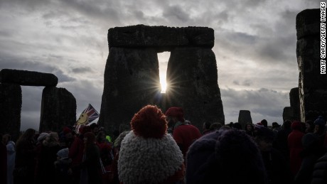 People look towards the sun as druids, pagans and revellers gather at Stonehenge, hoping to see the sun rise, as they take part in a winter solstice ceremony at the ancient neolithic monument of Stonehenge, UK.