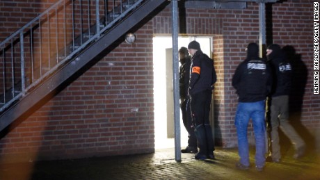 Police officers enter a refugee shelter Thursday in Emmerich, Germany.