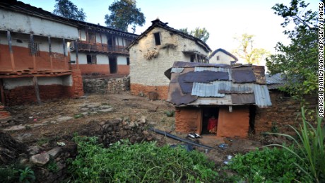 TO GO WITH Nepal-women-religion-society-chhaupadi,FEATURE by Frankie Taggart
Thirteen year old Nepalese villager Sarswati Biswokarma sits inside a &quot;chhaupadi house&quot; in the village of Achham, some 800kms west of Kathmandu on November 23, 2011.  Isolation is part of a centuries-old Hindu ritual known as chhaupadi which is blamed for prolongued depression, young women&#39;s deaths and high infant mortality rates in remote, impoverished western Nepal. Under the practice women are prohibited from participating in normal family activities during menstruation and after childbirth.     AFP PHOTO/Prakash MATHEMA (Photo credit should read PRAKASH MATHEMA/AFP/Getty Images)