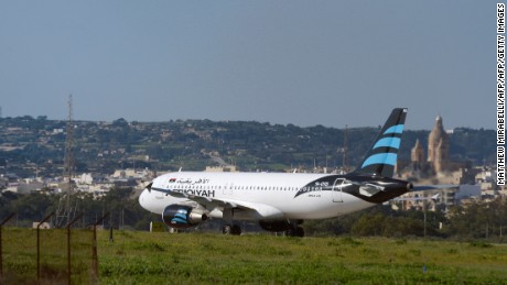 A picture taken on December 23, 2016 shows a hijacked Airbus A320 operated by Afriqiyah Airways after it landed at Luqa Airport, in Malta.
A hijacked plane from Libya landed on the Mediterranean island of Malta on December 23 with 118 people including seven crew members on board, Malta&#39;s prime minister and government sources said. The Airbus A320 had been on a domestic Libyan route operated by Afriqiyah Airways from Sabha in the south to the capital Tripoli but was re-routed.
 / AFP / Matthew Mirabelli / Malta OUT        (Photo credit should read MATTHEW MIRABELLI/AFP/Getty Images)