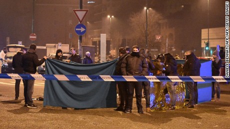 Italian police and forensics experts gather around the body of suspected Berlin truck attacker Anis Amri after he was shot dead in Milan on December 23, 2016.  
The Tunisian man suspected of carrying out the deadly Berlin truck attack at the Christmas market was shot dead by police in Milan on December 23, Italy's interior minister Marco Minniti said. The minister told a press conference in Rome that Anis Amri had been fatally shot after firing at two police officers who had stopped his car for a routine identity check around 3:00 am (0200 GMT). Identity checks had established "without a shadow of doubt" that the dead man was Amri, the minister said. / AFP / DANIELE BENNATI        (Photo credit should read DANIELE BENNATI/AFP/Getty Images)