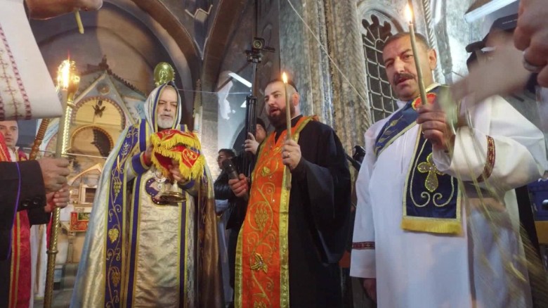 Clergymen hold Mass on Christmas Eve for people who returned to Bartella, Iraq, after ISIS militants had been driven out of the town.