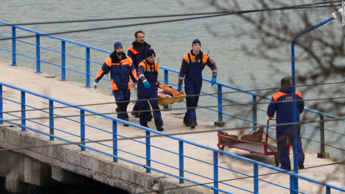 Russian emergency workers carry remains from the wreckage of the Tu-154 plane that crashed near Sochi on December 25. 