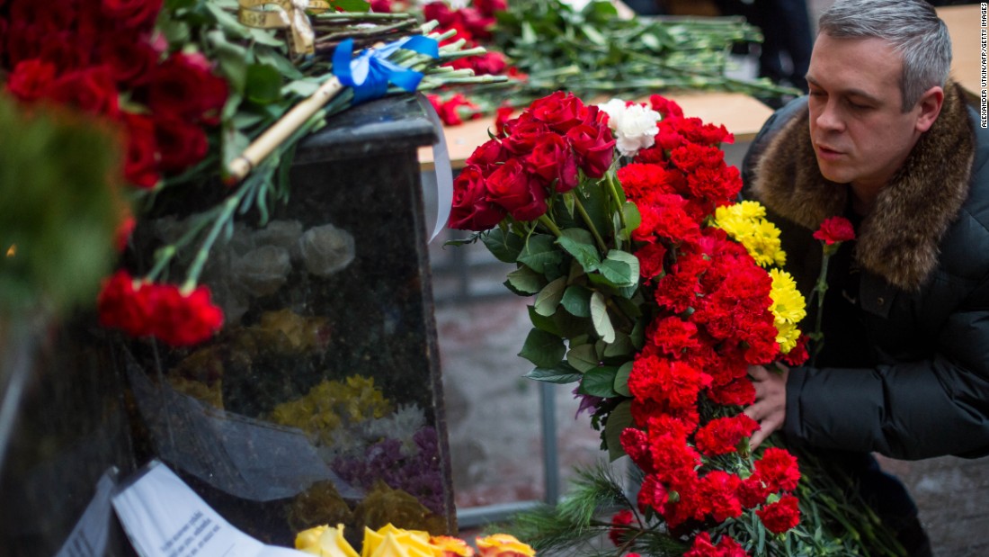 A man places flowers outside the building of the Alexandrov Ensemble in Moscow on Sunday. Alexander Kibovsky, head of Moscow&#39;s culture department, called them &quot;our cultural paratroopers.&quot;