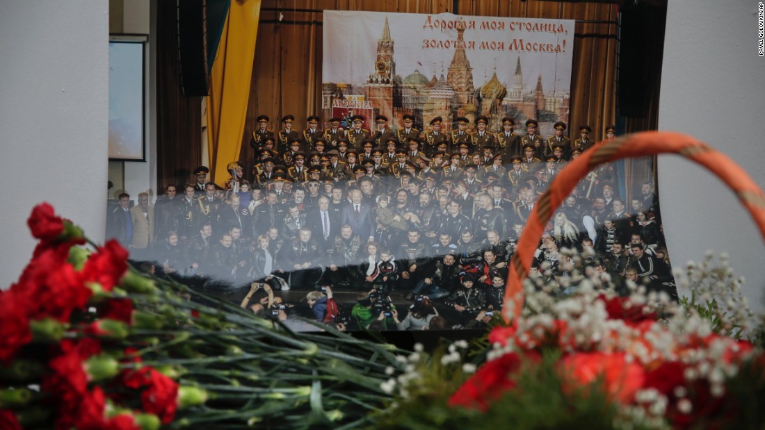 Flowers lay in front of a photo of the Alexandrov Ensemble at the group&#39;s building in Moscow. &quot;These people always performed in war zones, they wore uniforms, they brought kindness and light,&quot; Kibovsky said.