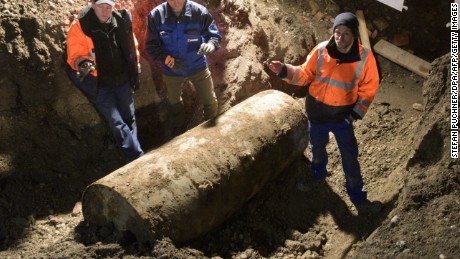 The bomb disposal team stand next to the World War II bomb they made safe in Augsburg, southern Germany, during a mass evacuation on December 25, 2016.