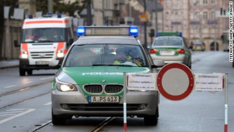 Police cars and an ambulance are seen beside a road block on an empty street in Augsburg, southern Germany, during a mass evacuation on Christmas Day.