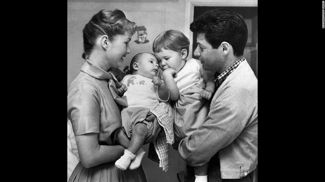 A family portrait with Debbie holding Todd and father Eddie holding Carrie.