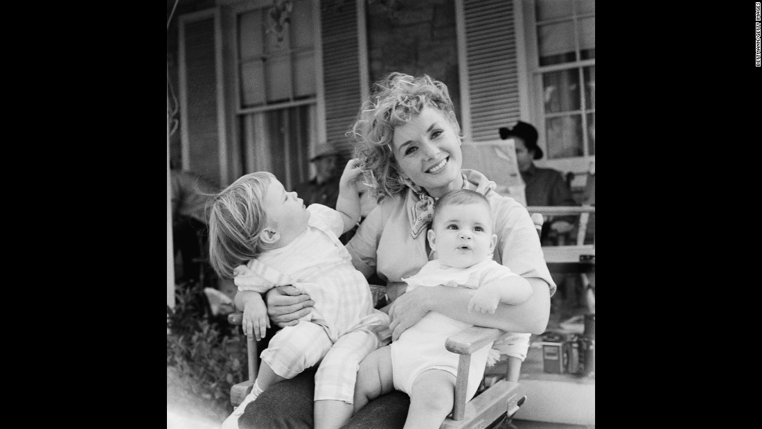 Reynolds holds her two children, Carrie and Todd, right, during the shooting of 1959&#39;s &quot;The Mating Game.&quot;